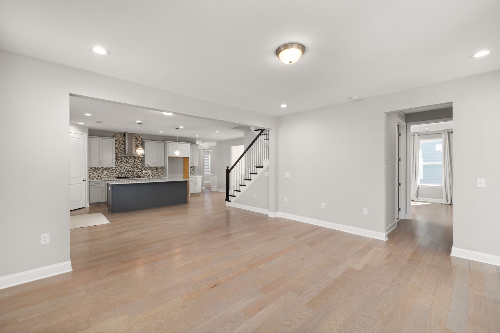 Engineered hardwood flooring installed across an open-concept room